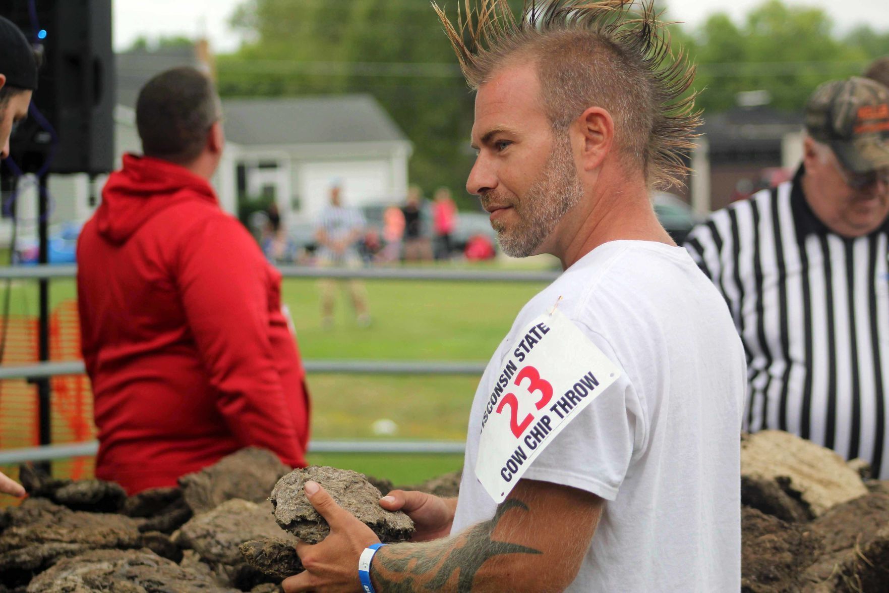 Dave picks out cow dung at cow chip toss